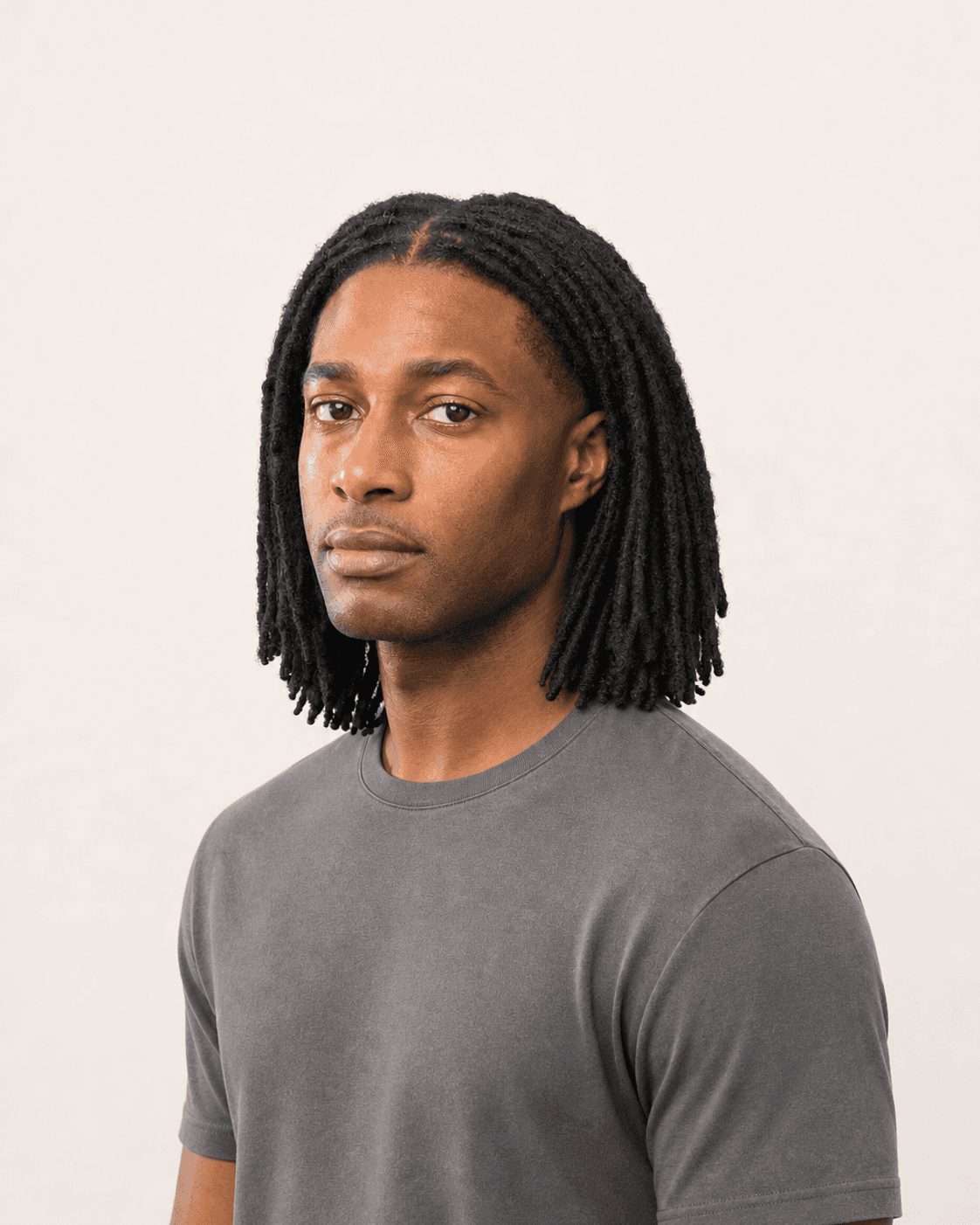 Three-quarter view of center-parted shoulder-length locs