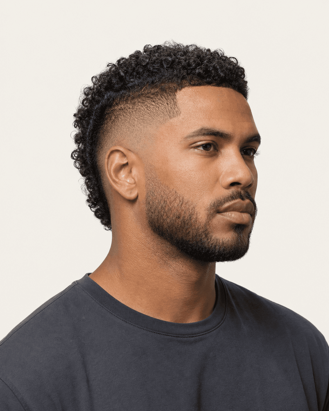 Three-quarter view of a burst fade with a curly mohawk