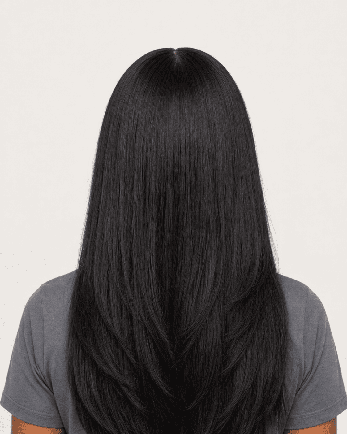 Rear view of a long silk press with a softly layered mid-chest perimeter