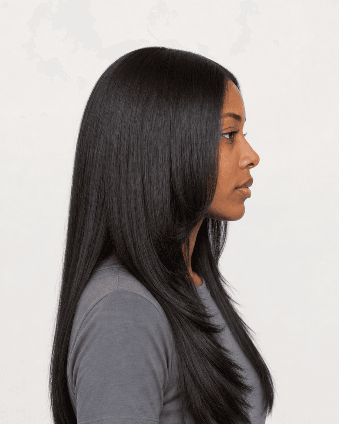 Side profile of a long silk press showing face-framing layers and body