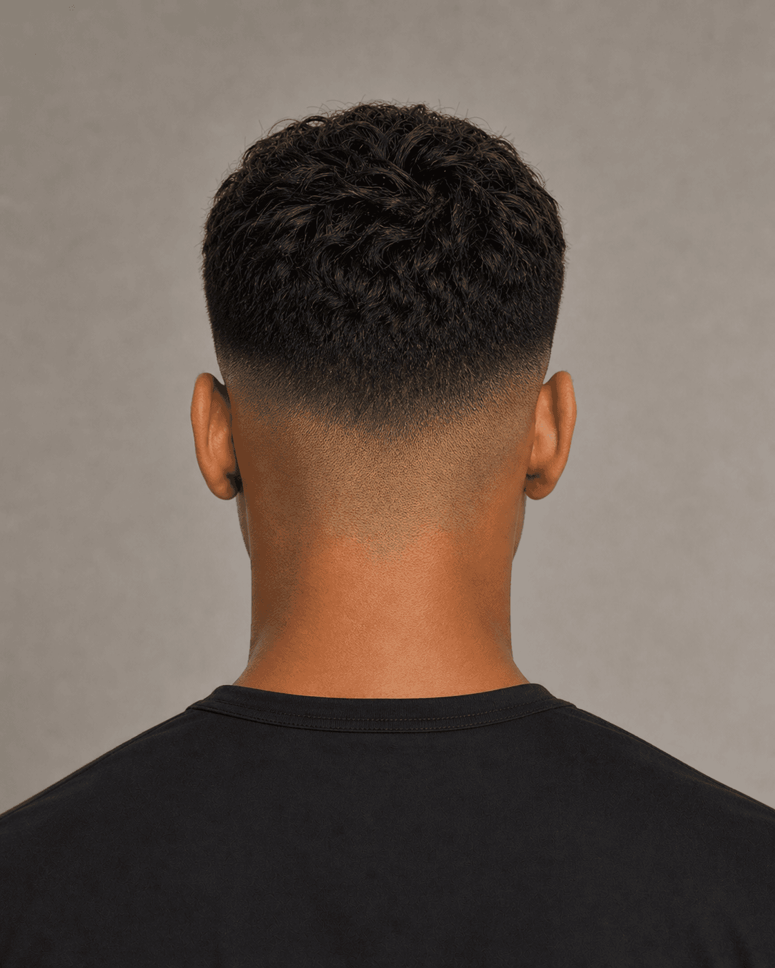 Rear view of a textured French crop showing the fade gradient, crown, and natural neckline